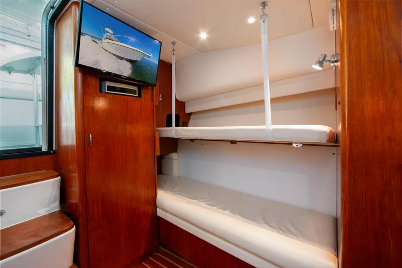 Slide: The Image of 2007 Tiara Yachts 3800 Open interior with bunk beds and mounted TV. - 32