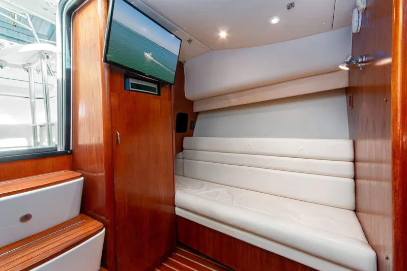 Slide: The Image of Interior of 2007 Tiara Yachts 3800 Open with white seating and mounted TV. - 33