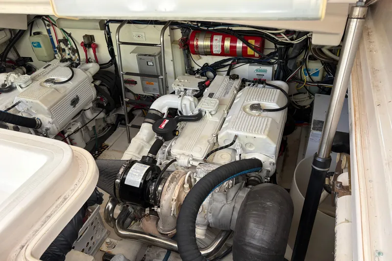 Slide: The Image of Engine room of a 2007 Tiara Yachts 3800 Open, showcasing dual engines and wiring. - 37