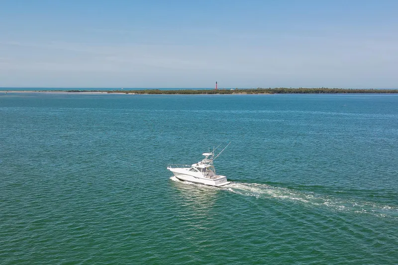 Slide: The Image of 2007 Tiara Yachts 3800 Open cruising on open water with distant shoreline. - 5