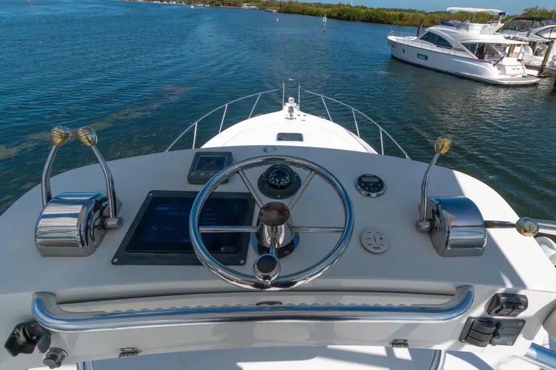 Slide: The Image of 2007 Tiara Yachts 3800 Open helm with steering wheel and controls on water. - 7