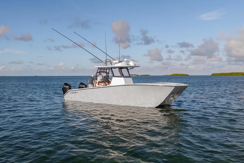 Slide: The Image of 2027 SeaHunter 32 CTS boat on calm water under a blue sky. - 3