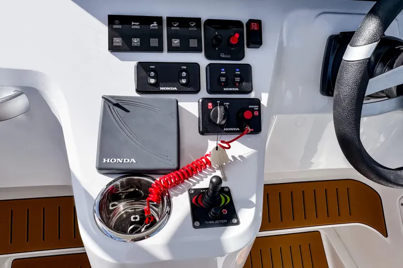 Slide: The Image of Control panel of 2025 STERK 31 boat with Honda components and steering wheel. - 12