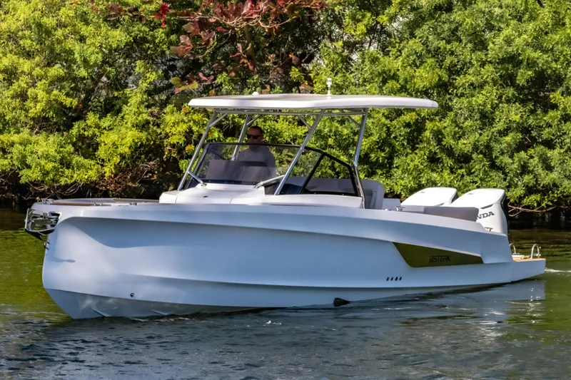 Slide: The Image of 2025 STERK 31 boat cruising on a calm river, surrounded by lush greenery. - 2
