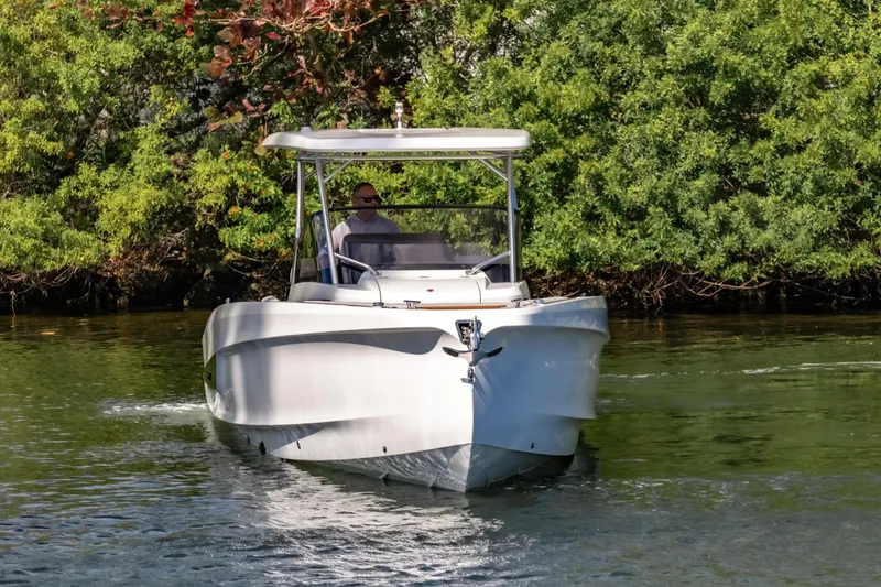 Slide: The Image of 2025 STERK 31 boat cruising on a serene river with lush greenery. - 3