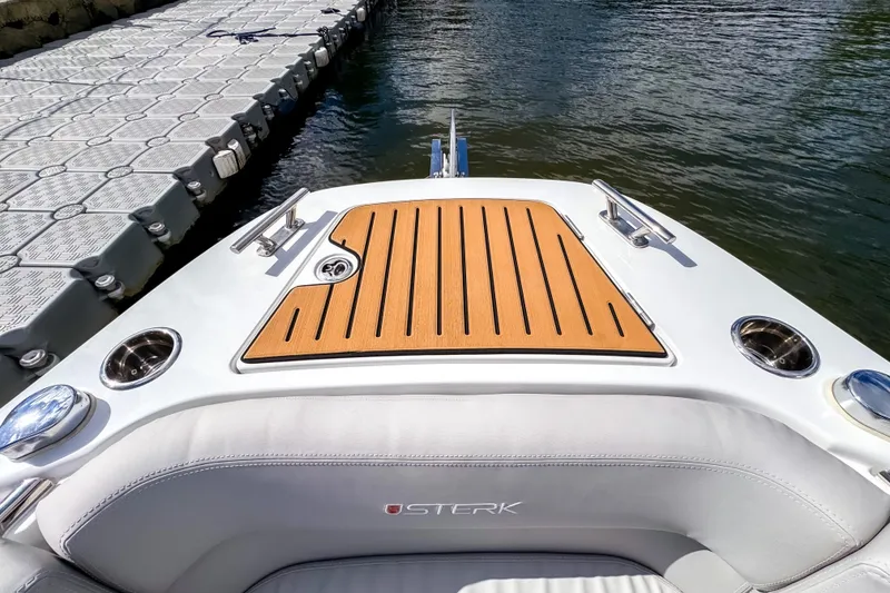 Slide: The Image of 2025 STERK 31 boat at dock, featuring sleek design and wooden deck accents. - 17