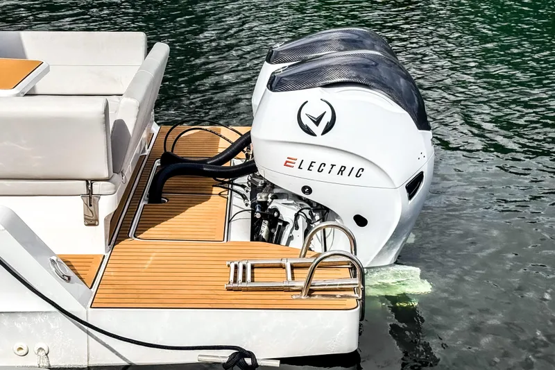 Slide: The Image of Electric outboard motor on STERK 31 boat, 2025 model, docked on water. - 5