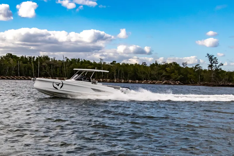 Slide: The Image of 2025 STERK 31 boat cruising on a scenic river under a blue sky. - 18