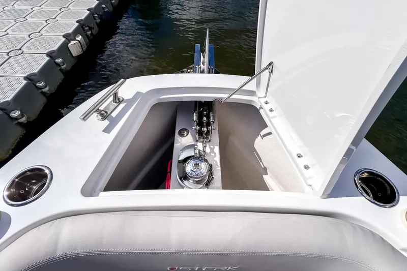 Slide: The Image of Open anchor compartment on 2025 STERK 31 boat, dockside view. - 14