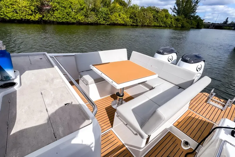 Slide: The Image of 2025 STERK 31 boat with modern seating and dual engines on a scenic river. - 6