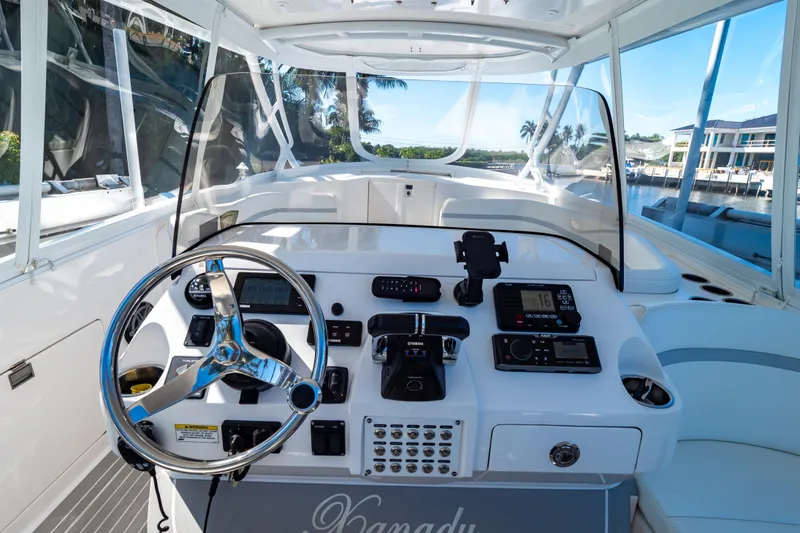 Slide: The Image of Helm of 2016 Intrepid 400 Cuddy boat with modern controls and steering wheel. - 103