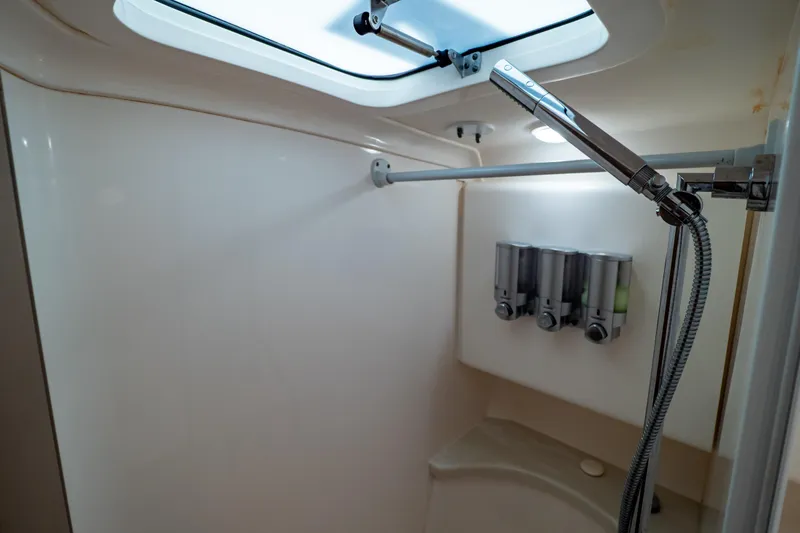Slide: The Image of Shower area in 2016 Intrepid 400 Cuddy boat with dispensers and skylight. - 115