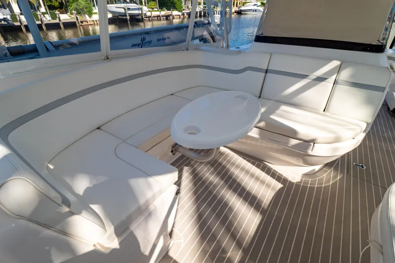 Slide: The Image of Luxurious seating area on a 2016 Intrepid 400 Cuddy boat, featuring a sleek white design. - 116