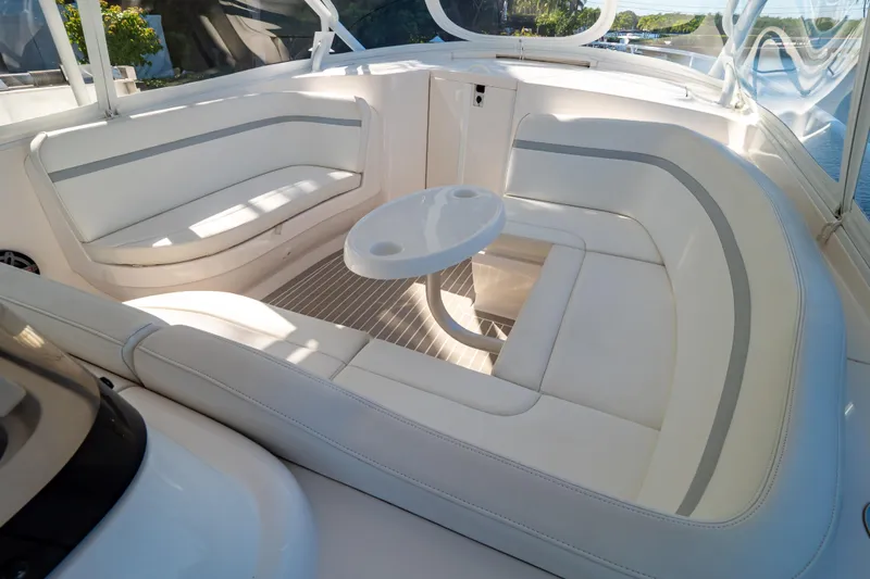 Slide: The Image of Luxurious seating area on a 2016 Intrepid 400 Cuddy boat, featuring white cushioned seats. - 121