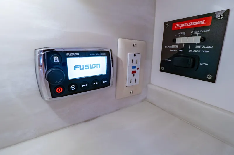 Slide: The Image of Control panel and outlet on 2016 Intrepid 400 Cuddy boat interior. - 127