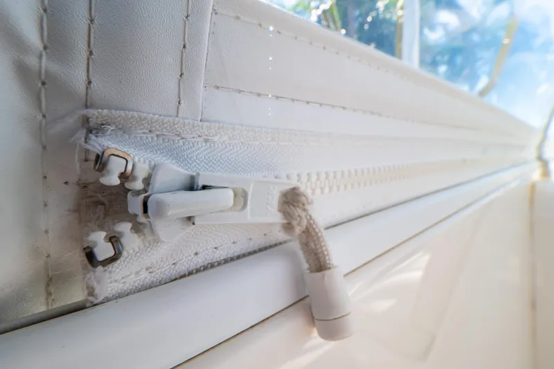 Slide: The Image of Close-up of a white zipper on a 2016 Intrepid 400 Cuddy boat. - 128