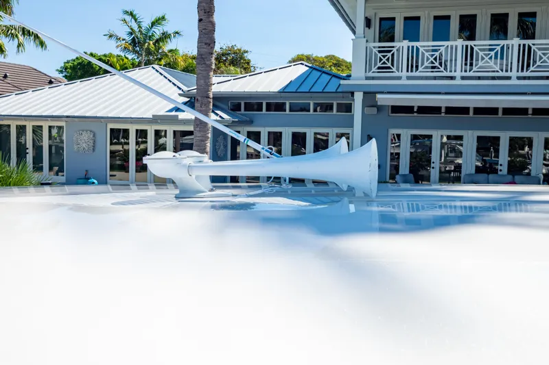 Slide: The Image of 2016 Intrepid 400 Cuddy boat with sleek design, docked near a modern waterfront home. - 129