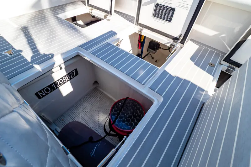 Slide: The Image of Open storage compartments on a 2016 Intrepid 400 Cuddy boat deck. - 130