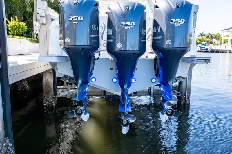 Slide: The Image of Triple Yamaha 350 V8 engines on a 2016 Intrepid 400 Cuddy boat docked by water. - 132