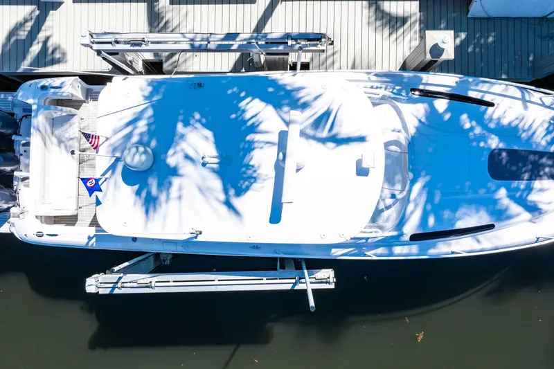 Slide: The Image of Overhead view of a 2016 Intrepid 400 Cuddy boat docked, with palm shadows. - 133