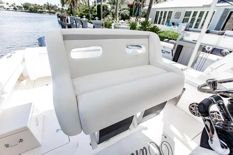 Slide: The Image of 2016 Intrepid 400 Cuddy boat interior with plush seating and modern controls. - 17