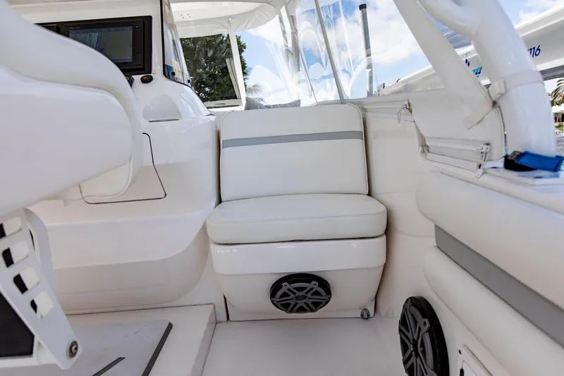 Slide: The Image of Interior of 2016 Intrepid 400 Cuddy boat with white seating and modern controls. - 25