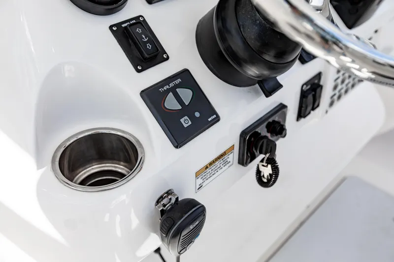 Slide: The Image of Control panel of a 2016 Intrepid 400 Cuddy boat with thruster controls. - 26