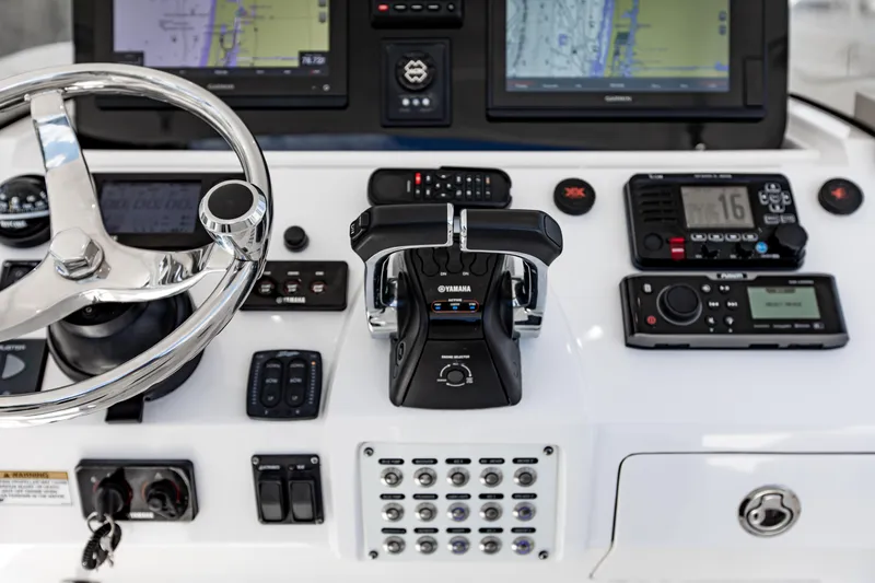 Slide: The Image of Control panel of a 2016 Intrepid 400 Cuddy boat with navigation and communication systems. - 27