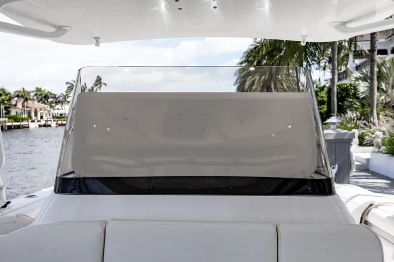 Slide: The Image of 2016 Intrepid 400 Cuddy boat windshield with waterfront view and palm trees. - 31