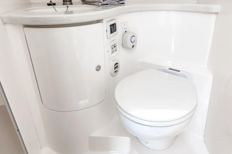 Slide: The Image of Compact marine bathroom in 2016 Intrepid 400 Cuddy, featuring toilet and sink. - 34
