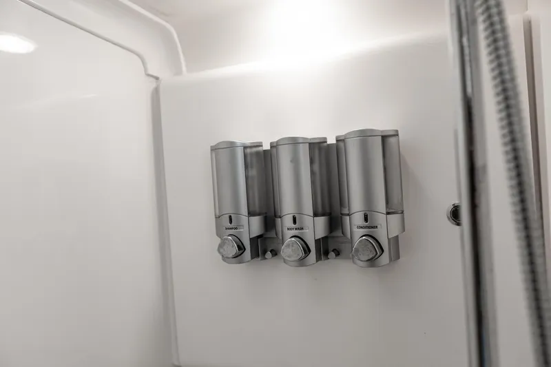 Slide: The Image of Wall-mounted shower dispensers in a 2016 Intrepid 400 Cuddy boat bathroom. - 35