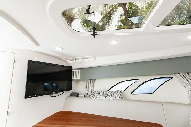 Slide: The Image of Interior of 2016 Intrepid 400 Cuddy with TV, skylight, and modern seating. - 37