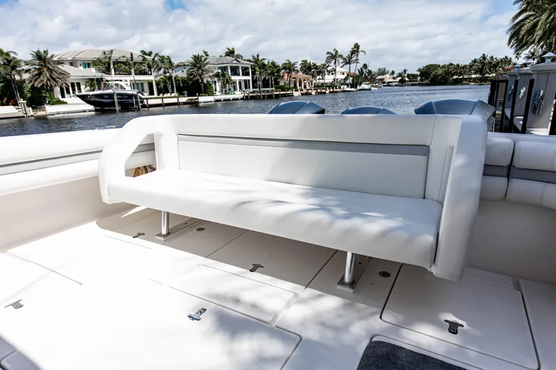 Slide: The Image of Luxury seating on 2016 Intrepid 400 Cuddy boat, docked by waterfront homes. - 4