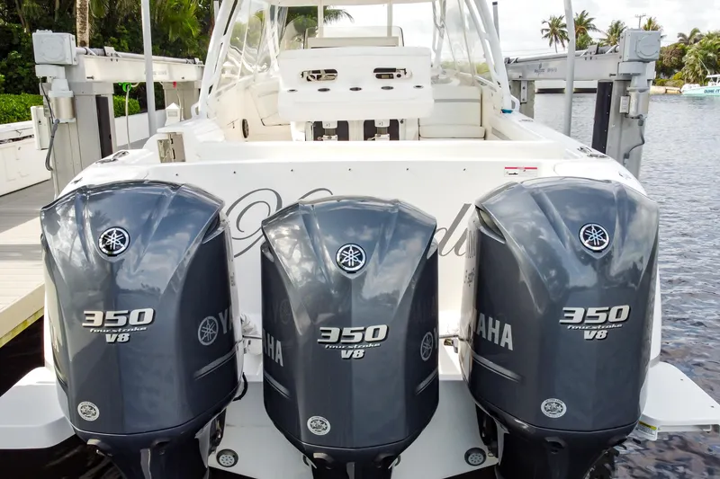 Slide: The Image of 2016 Intrepid 400 Cuddy with triple Yamaha 350 V8 engines docked by water. - 43