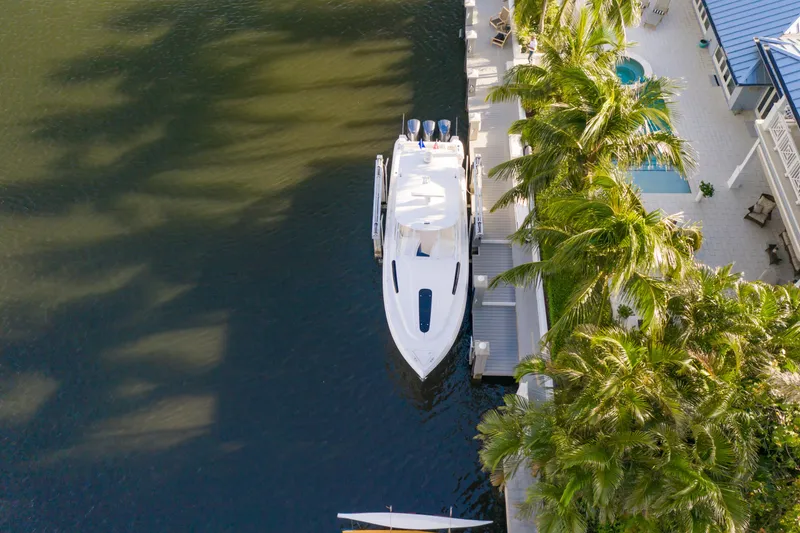 Slide: The Image of Aerial view of 2016 Intrepid 400 Cuddy yacht docked by palm trees. - 44