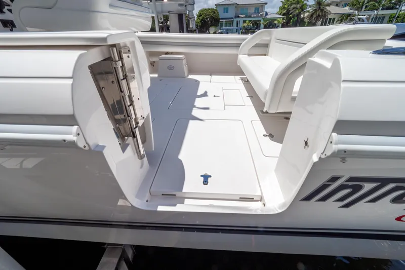 Slide: The Image of 2016 Intrepid 400 Cuddy boat interior with open hatch and seating area. - 46