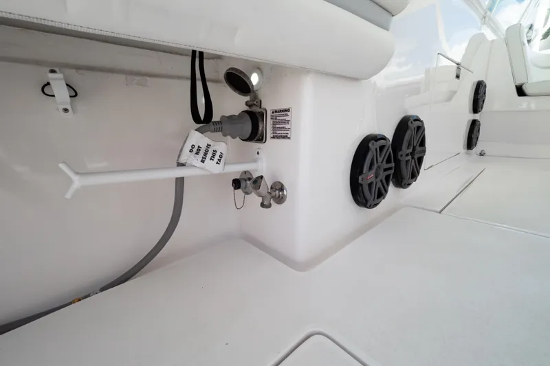 Slide: The Image of 2016 Intrepid 400 Cuddy boat interior with speakers and utility connections. - 48