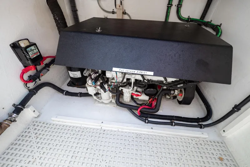 Slide: The Image of Engine compartment of a 2016 Intrepid 400 Cuddy boat, showcasing mechanical components. - 49