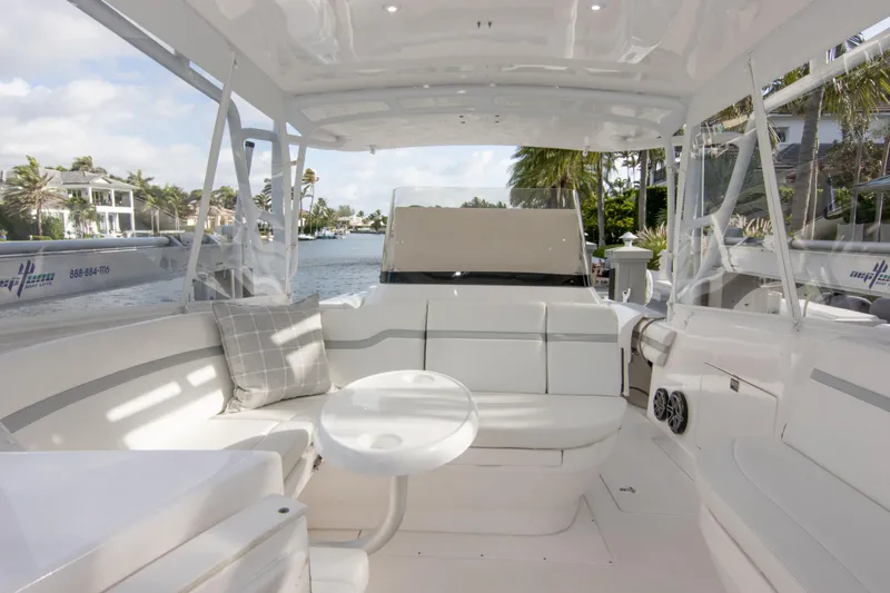 Slide: The Image of Luxurious 2016 Intrepid 400 Cuddy boat interior with white seating and waterfront view. - 5