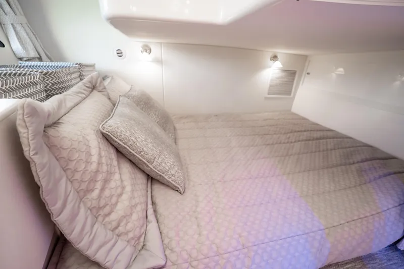Slide: The Image of Luxurious 2016 Intrepid 400 Cuddy cabin interior with cozy bedding and ambient lighting. - 58