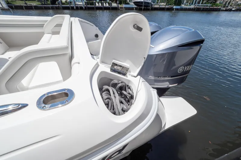 Slide: The Image of 2016 Intrepid 400 Cuddy boat with open storage compartment and Yamaha outboard engines. - 62
