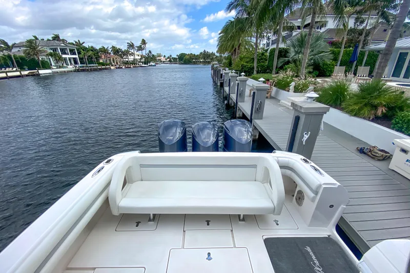 Slide: The Image of Intrepid 400 Cuddy 2016 docked by a scenic waterfront with palm trees. - 65