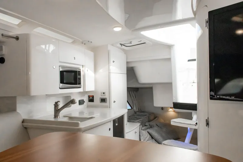 Slide: The Image of Interior of 2016 Intrepid 400 Cuddy boat with modern kitchen and cozy sleeping area. - 67