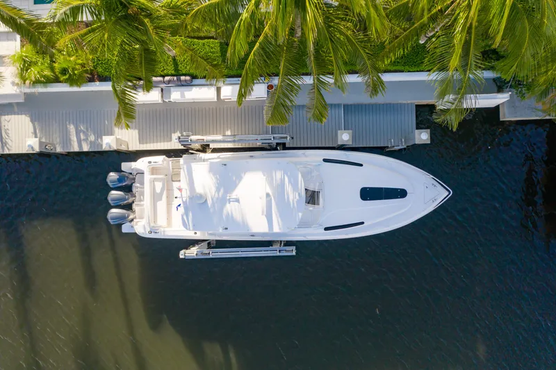 Slide: The Image of Aerial view of 2016 Intrepid 400 Cuddy yacht docked by palm trees. - 68