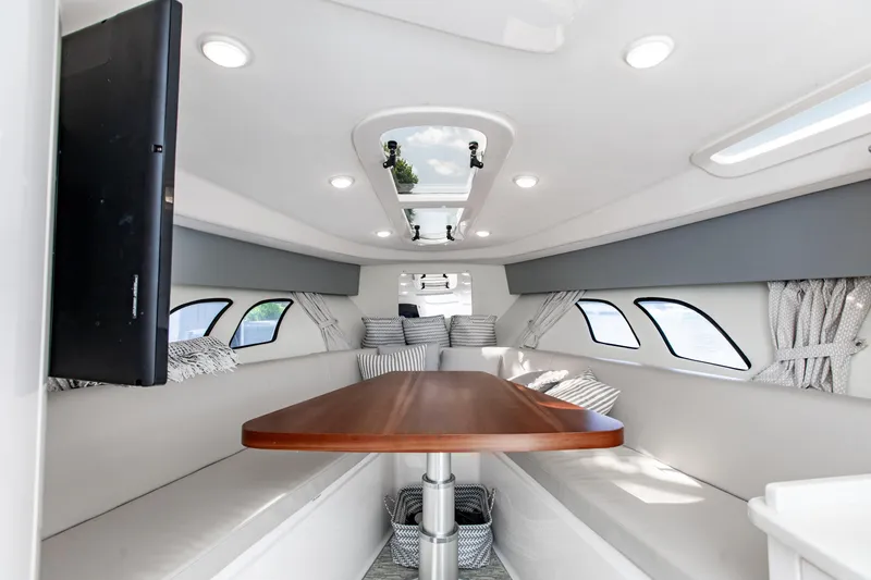 Slide: The Image of Luxurious interior of 2016 Intrepid 400 Cuddy boat with elegant seating and wooden table. - 7