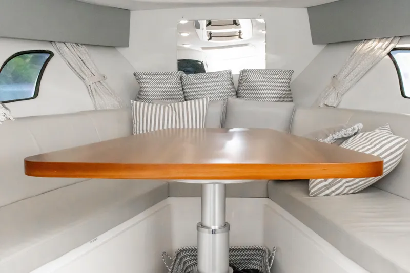 Slide: The Image of Interior of 2016 Intrepid 400 Cuddy with wooden table and cushioned seating. - 71