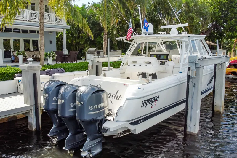 Slide: The Image of 2016 Intrepid 400 Cuddy boat docked with triple Yamaha engines. - 73