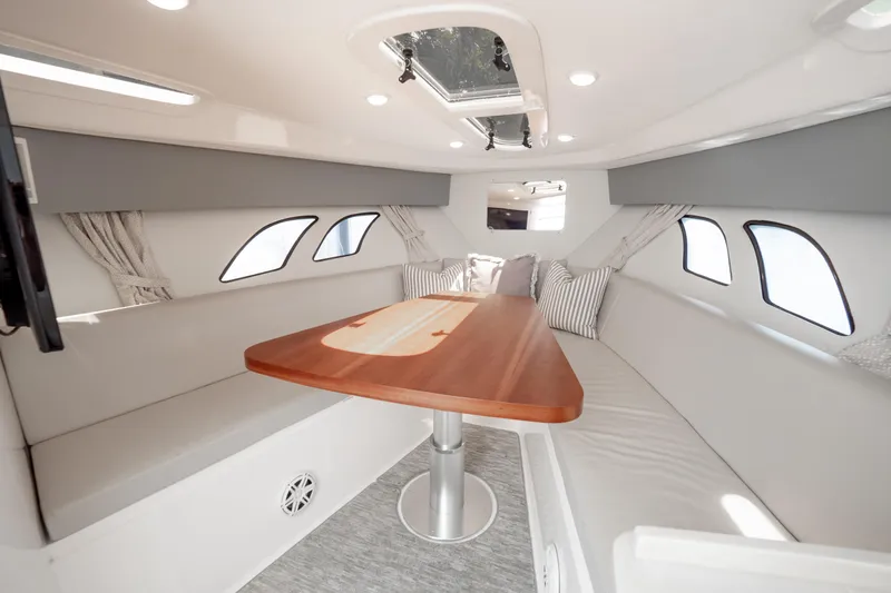 Slide: The Image of 2016 Intrepid 400 Cuddy interior with elegant seating and wooden table. - 83