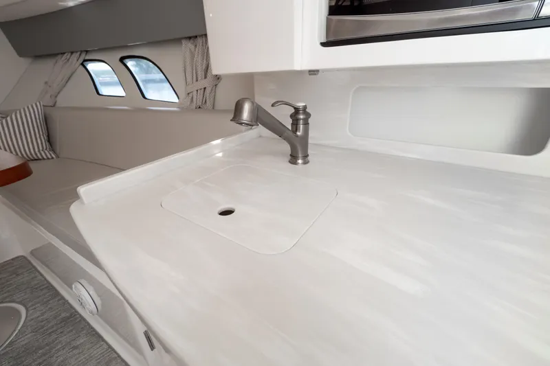 Slide: The Image of 2016 Intrepid 400 Cuddy interior with sleek countertop and modern faucet design. - 85