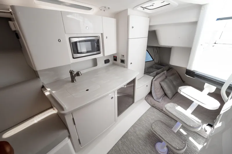 Slide: The Image of Interior of 2016 Intrepid 400 Cuddy boat featuring modern kitchenette and cozy seating area. - 9